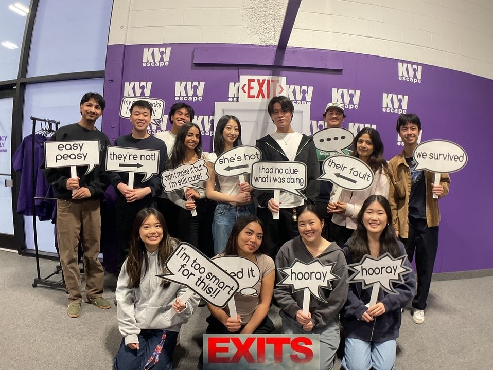 The team holding signs at an event